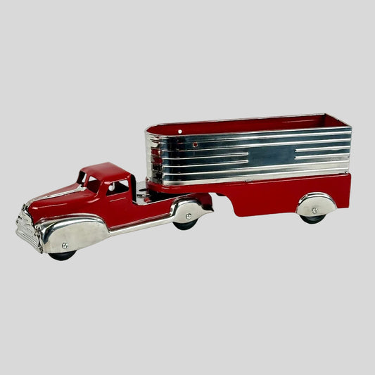 Model of a red truck with a silver trailer on a white background
