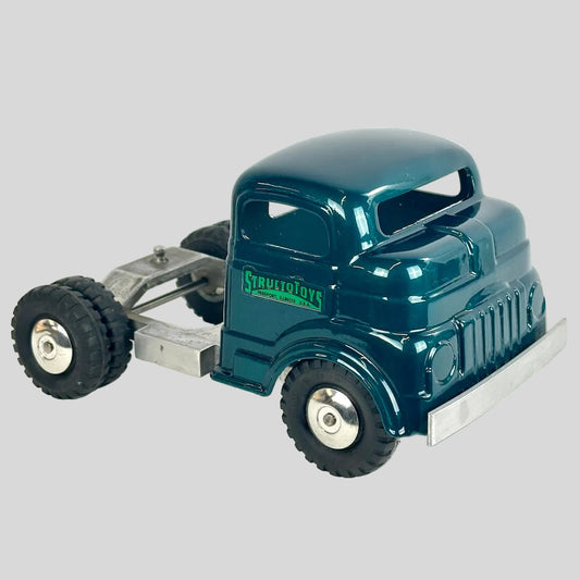 Model truck with 'Structo Toys' branding on a white background