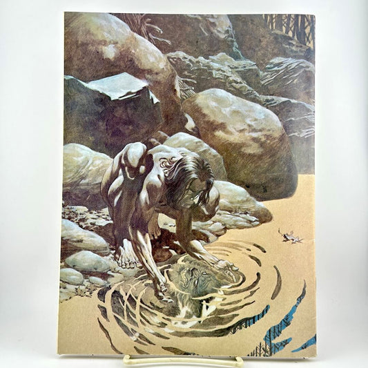 A vintage illustrated back magazine cover depicting a nude figure reaching into rippling water among large rocks.