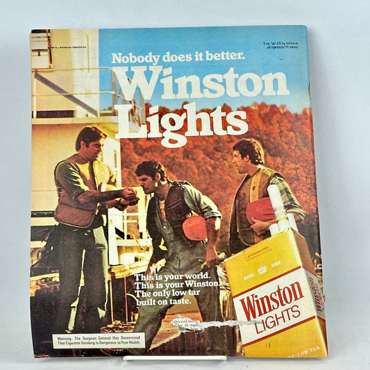 Vintage Winston Lights cigarette ad with a printed photo of three men outdoors.