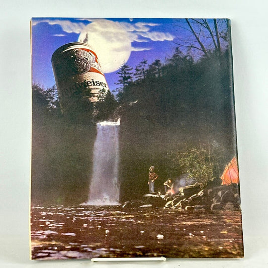 Back cover of magazine with full page Budweiser ad of nature scene with beer can at top of waterfall.