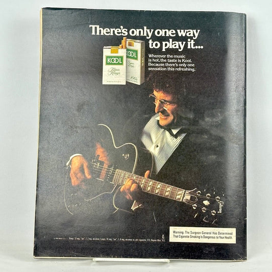 Back cover of magazine with full page ad for KOOL cigarettes featuring man in tuxedo playing guitar.