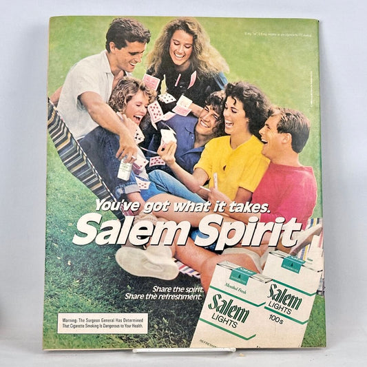 Back cover of magazine with full page ad for Salem cigarettes featuring image of group of people playing cards in hammock.