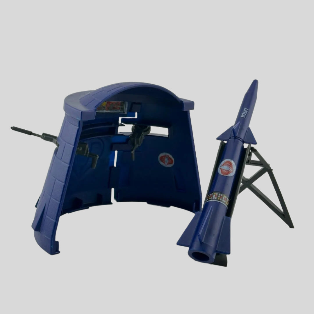 Navy blue bunker with two grey machine guns, separate navy rocket with rey stand, all with red Cobra stickers.