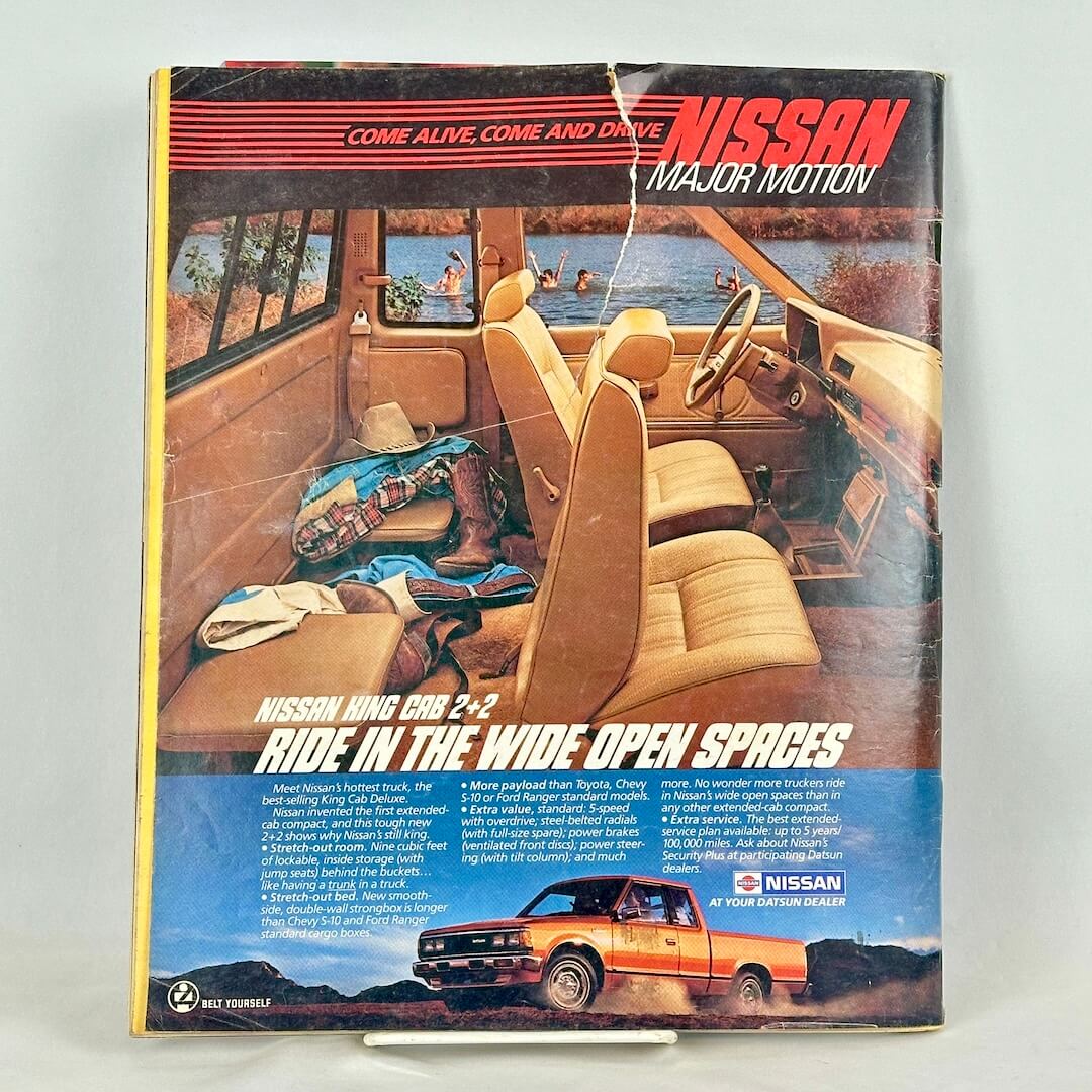 Back cover of magazine with full page ad for Nissan Datsun showing interior and exterior shots of the vehicle.