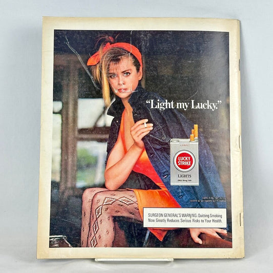 Back cover of magazine with full page ad for Lucky Strike cigarettes featuring a woman in jean jacket holding a cigarette.