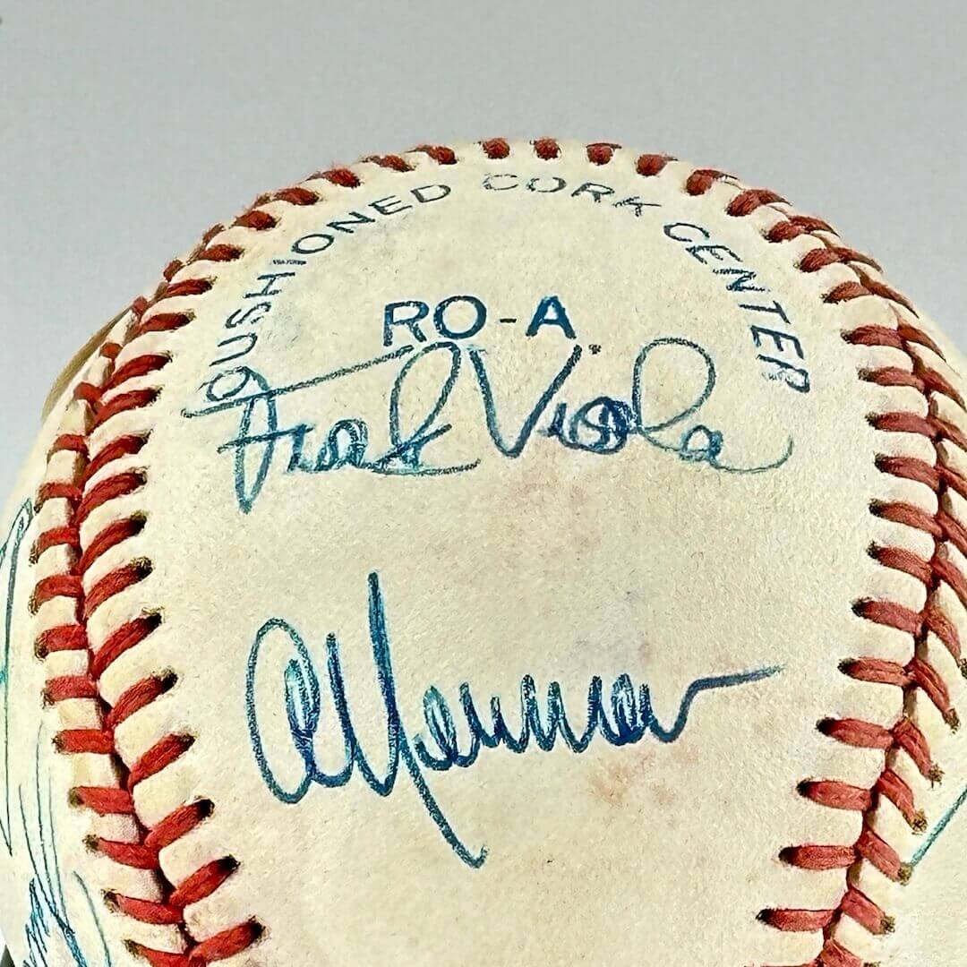 White baseball with two hand signatures in blue ink.