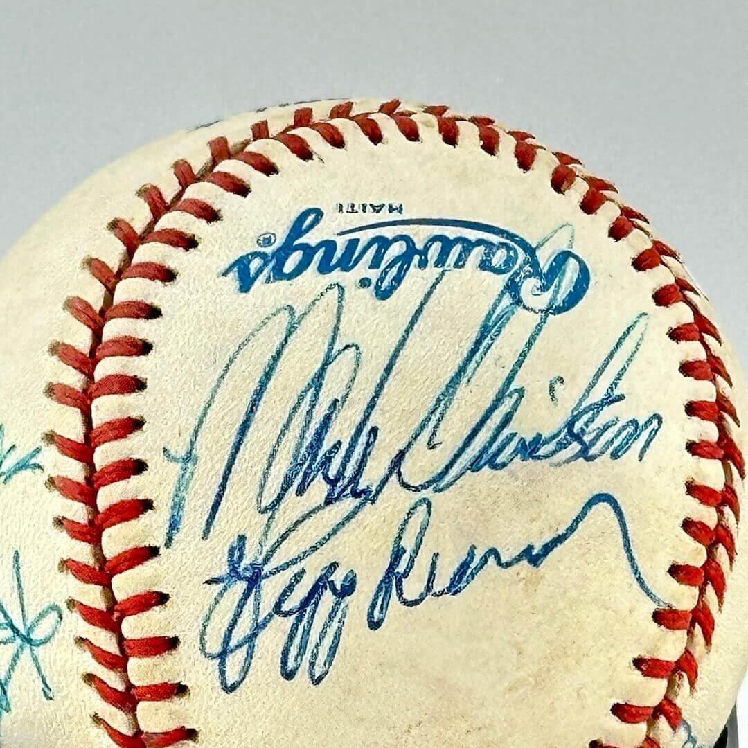 White baseball with two hand signatures in blue ink under Rawlings logo.