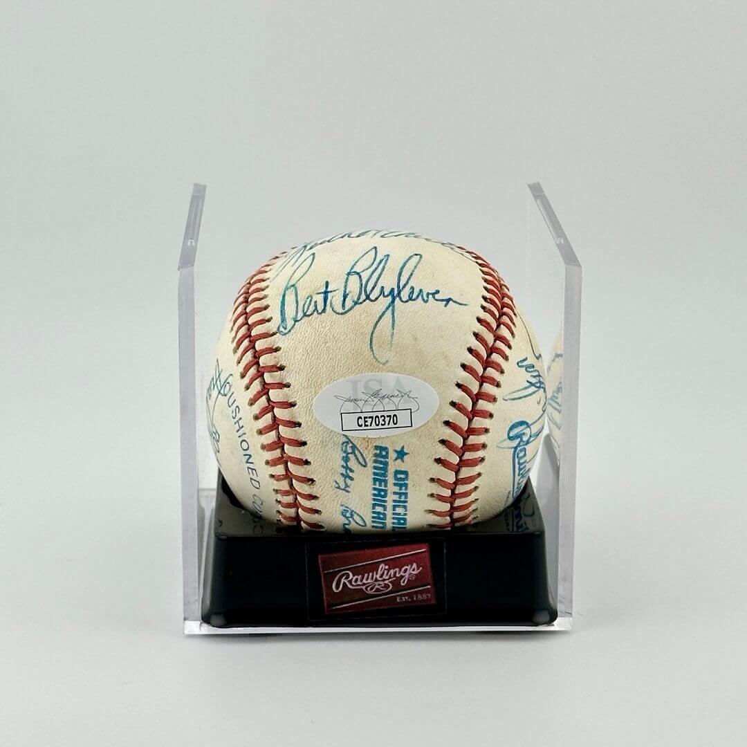 Autographed baseball in plastic cube with JSA sticker label in middle.