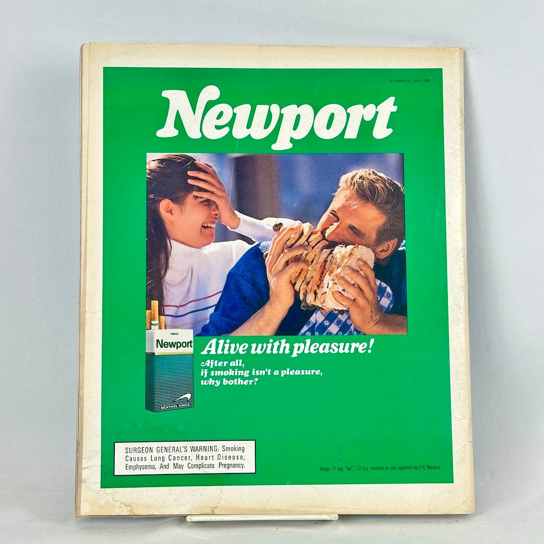 Back cover of magazine with full page ad for Newport cigarettes featuring man eating a sandwich and disgusted woman.