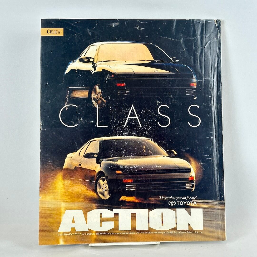 Back cover of magazine with full page ad for Toyota Celica featuring two 3/4 views of black vehicle.