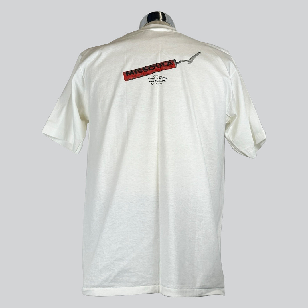Back of a white Pearl Jam t-shirt featuring a red firecracker graphic with the word 'Missoula' written on it.