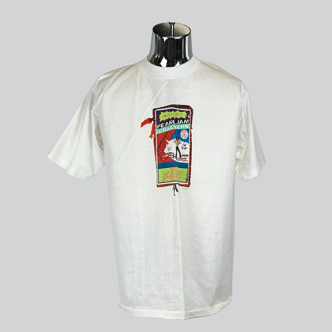 White Pearl Jam T-shirt with colorful concert-themed graphic, featuring stylized text and imagery in a vintage concert poster style.