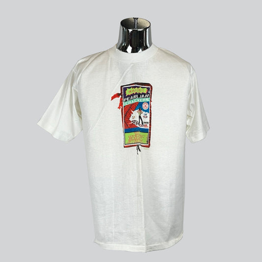 White Pearl Jam T-shirt with colorful concert-themed graphic, featuring stylized text and imagery in a vintage concert poster style.