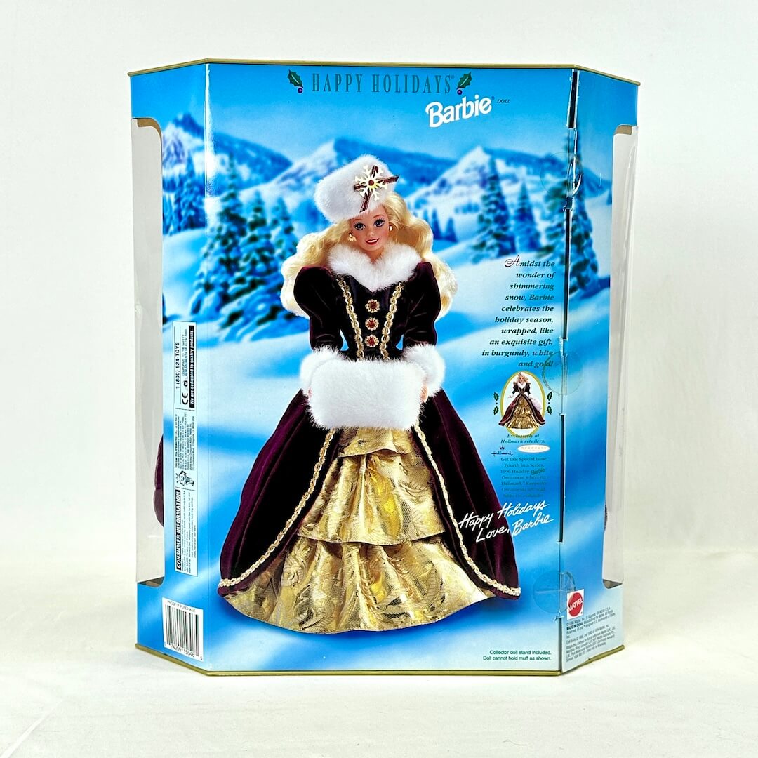 Barbie doll in holiday dress packaging with snowy landscape