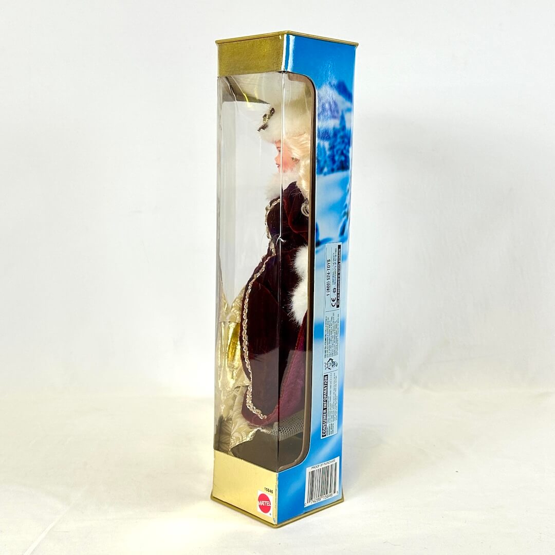 Barbie in Holiday dress still sealed in packaging, side view.