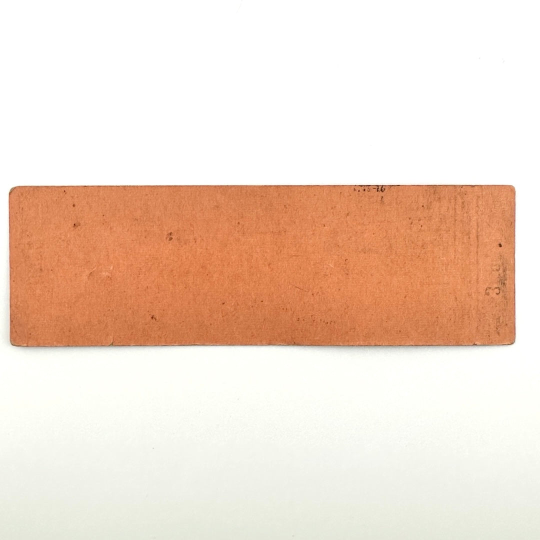 Backside of orange rectangular ticket with some ink transfer and a small amount of dirt, no other damage.