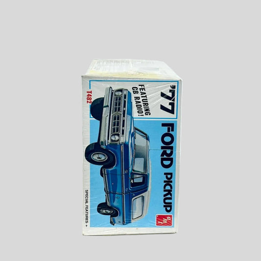 Model kit for '77 Ford Pickup still in plastic wrap against white background.