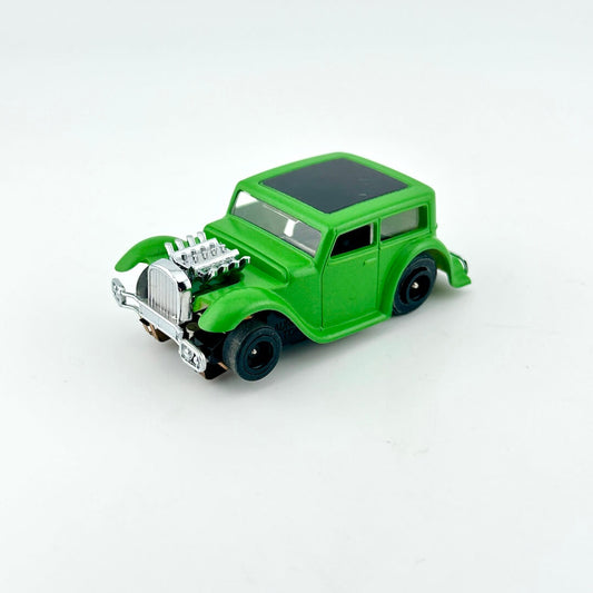 Green toy car with a detailed engine on a white background