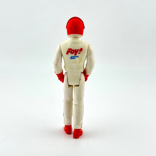 Action figure in a beige suit with red shoes and helmet on a white background