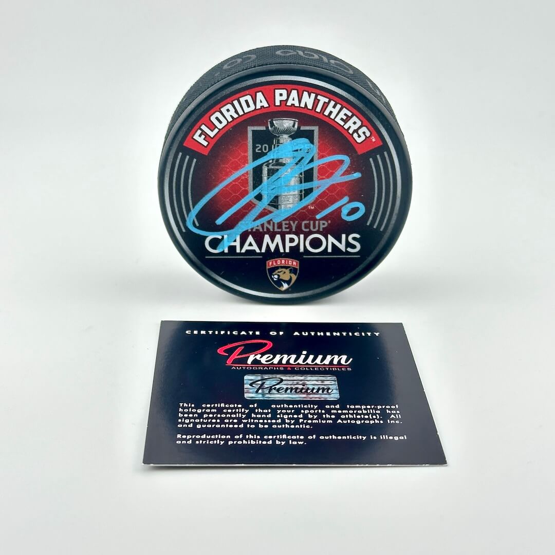 Puck with Florida Panthers Stanley Cup Champions branding and a certificate of authenticity on a white background