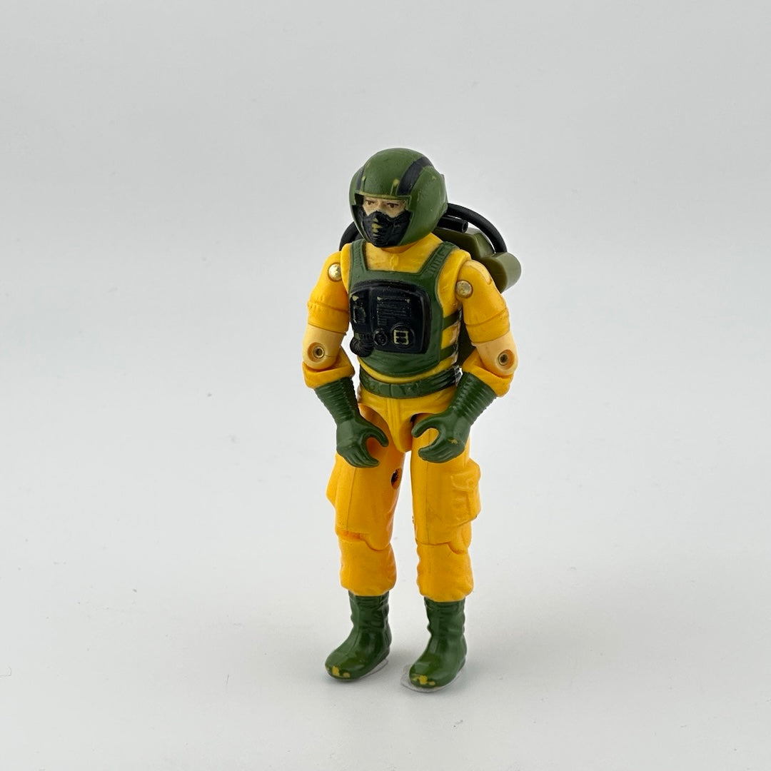 Action figure in yellow wetsuit with olive green accents, like shoes, gloves, harness, helmet, etc.