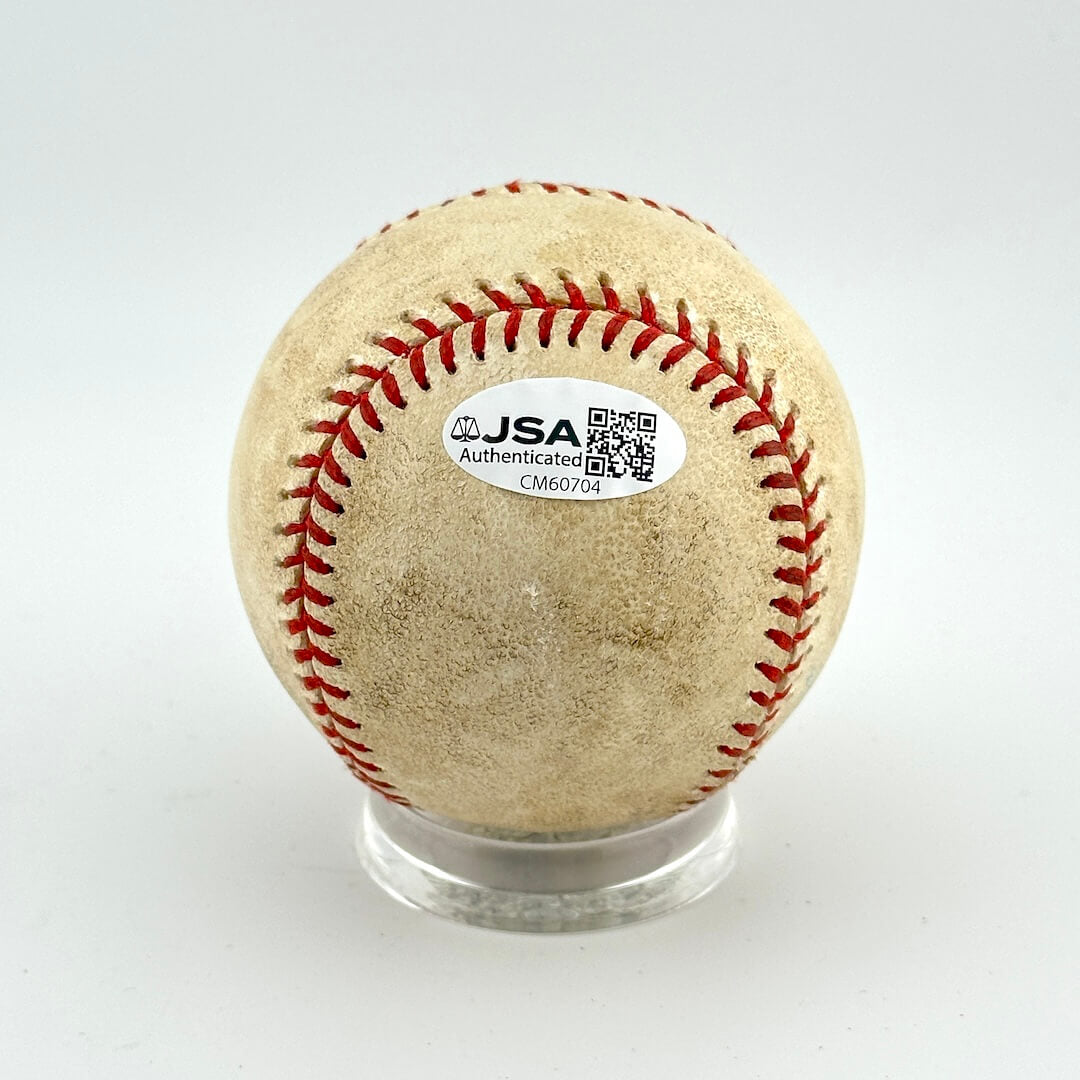 Baseball with JSA authentication label on a white background