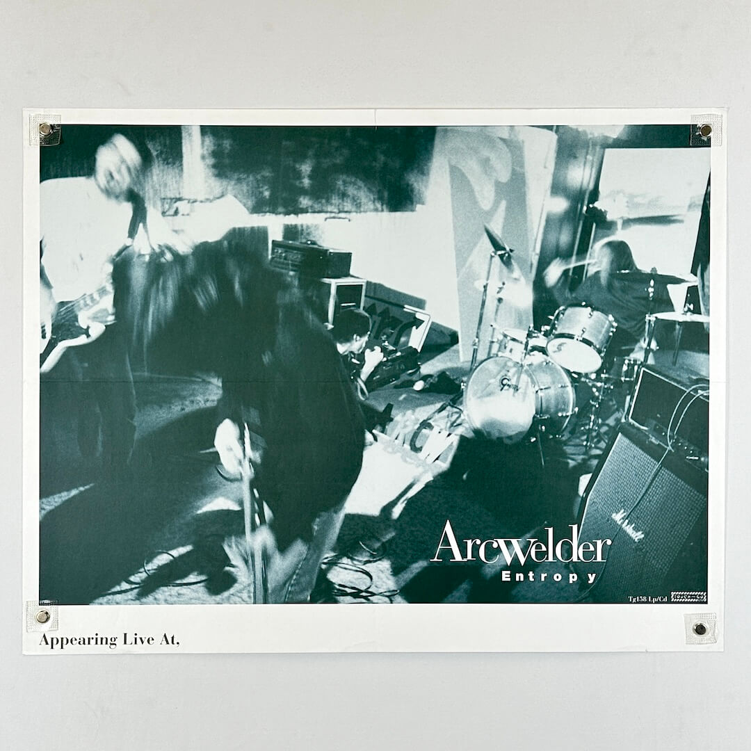 Black and white photo of a band performing with 'Arcwelder Entropy' branding.