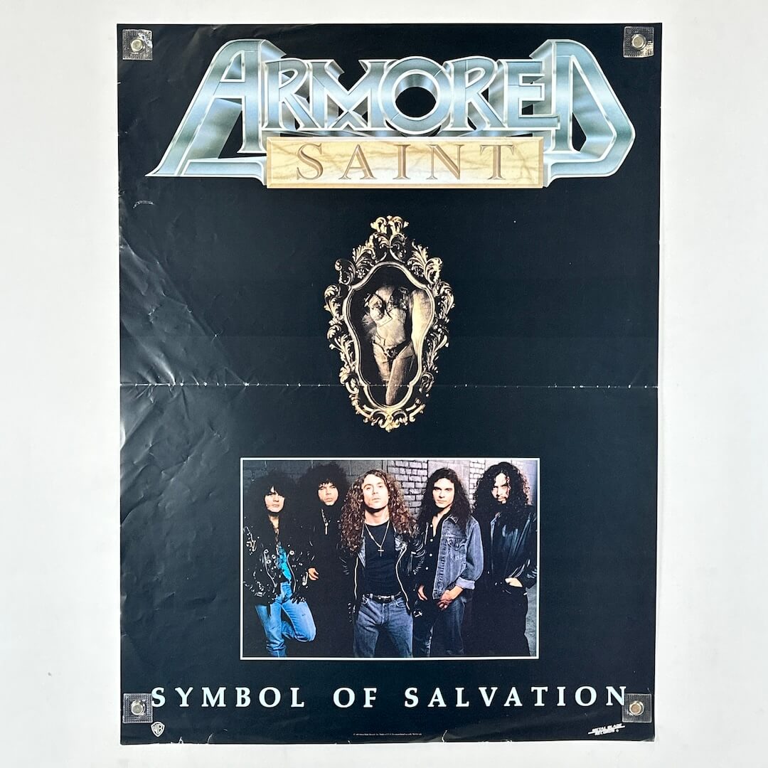 Poster of album cover for 'Symbol of Salvation' by Armored Saint with band photo and ornate design.