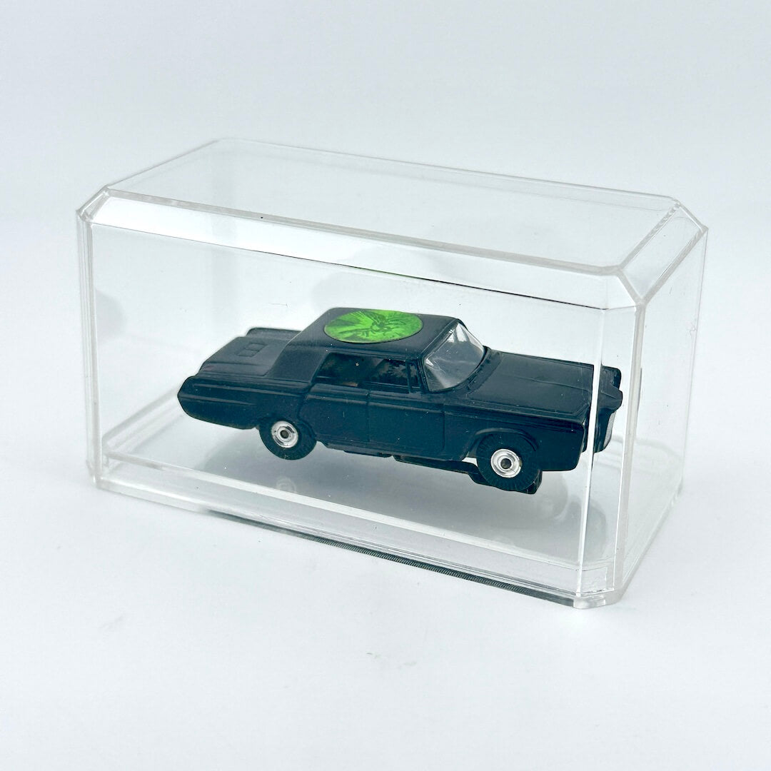 Model car in a clear display case on a white background