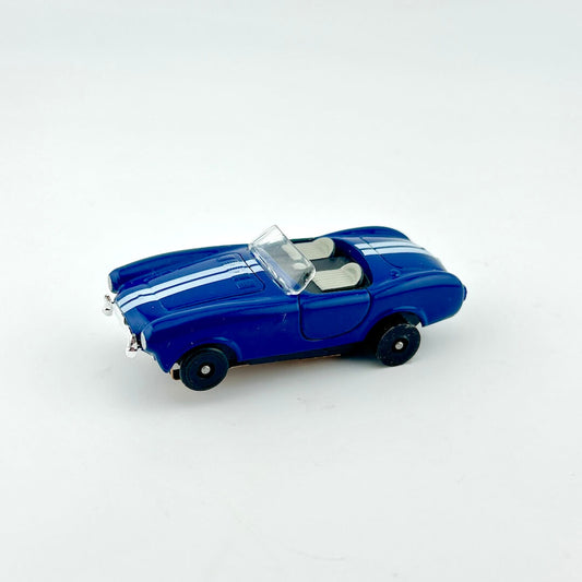 Blue model car with white stripes on a white background