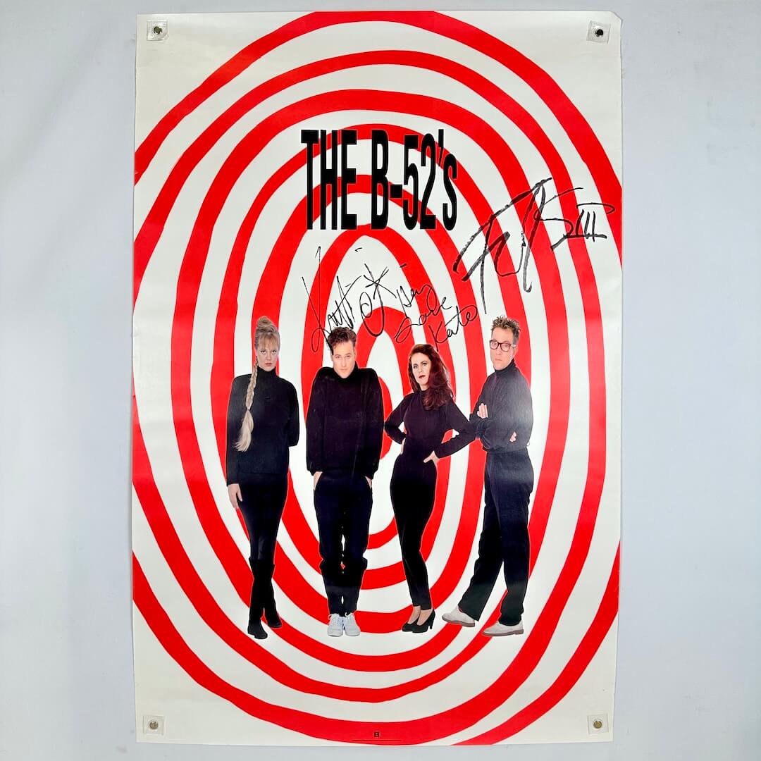 Poster of The B-52s with red and white spiral design on a gray background