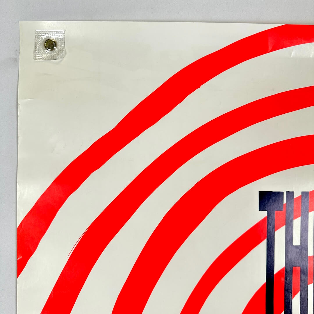 Top left corner of poster with crease by corner and at top.