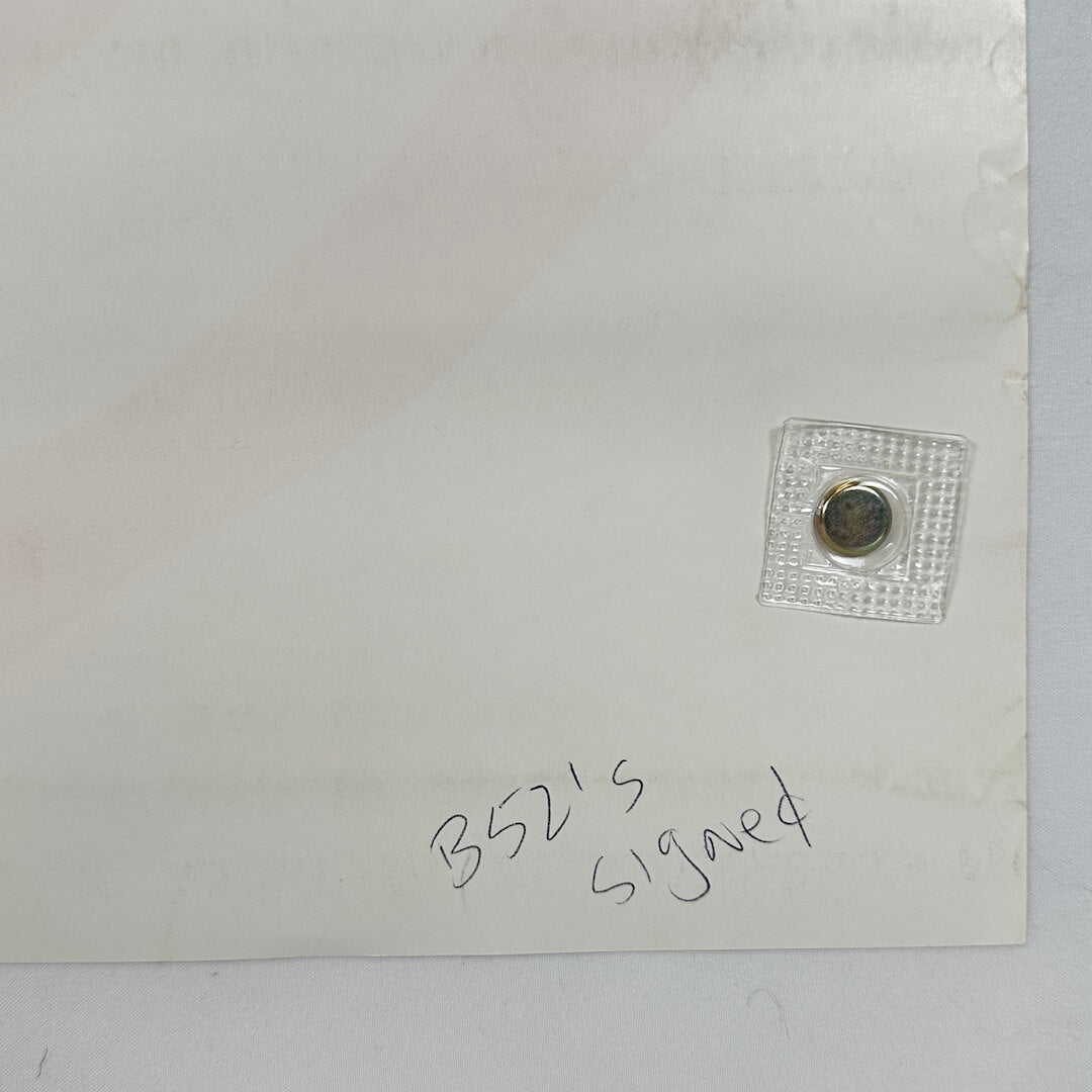 Backside corner where someone has written "B52's Signed" in pen.