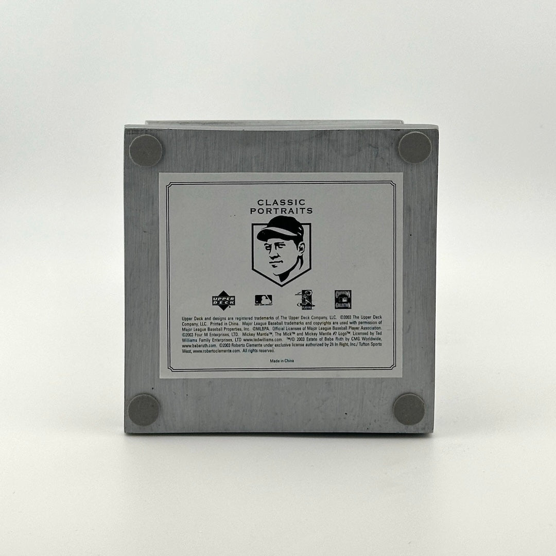 Bottom of pedestal with silver sticker with player and manufacturer information.