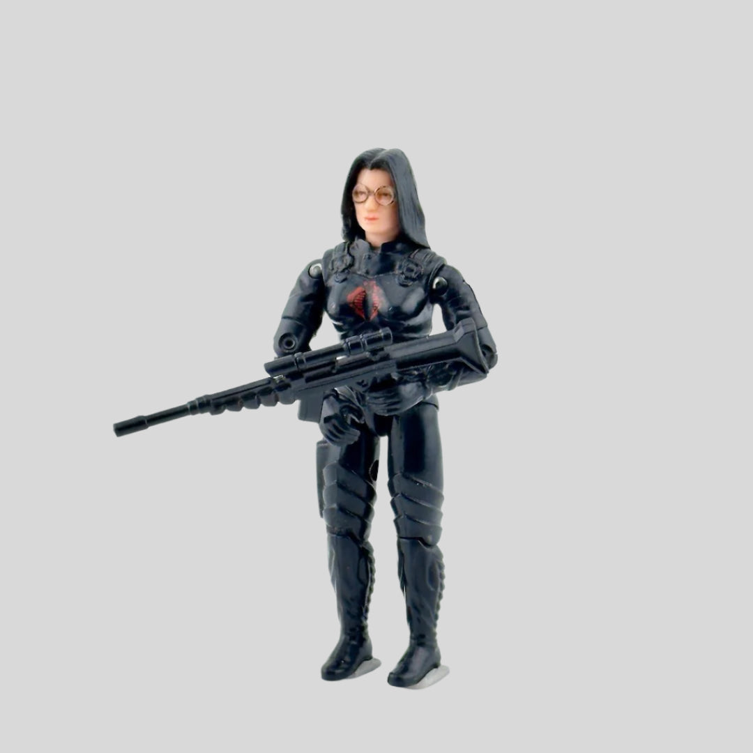 White woman with glasses dressed in all black with black rifle, red COBRA symbol on chest.