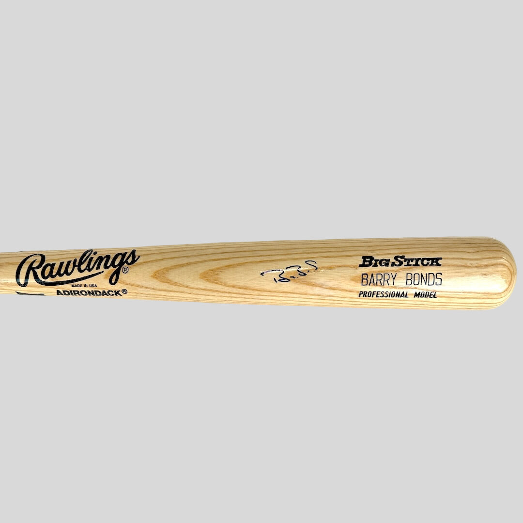 Baseball bat with text and signature against gray background.
