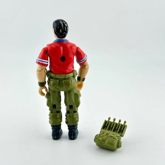 Back of GI Joe action figure with accessory against white background.