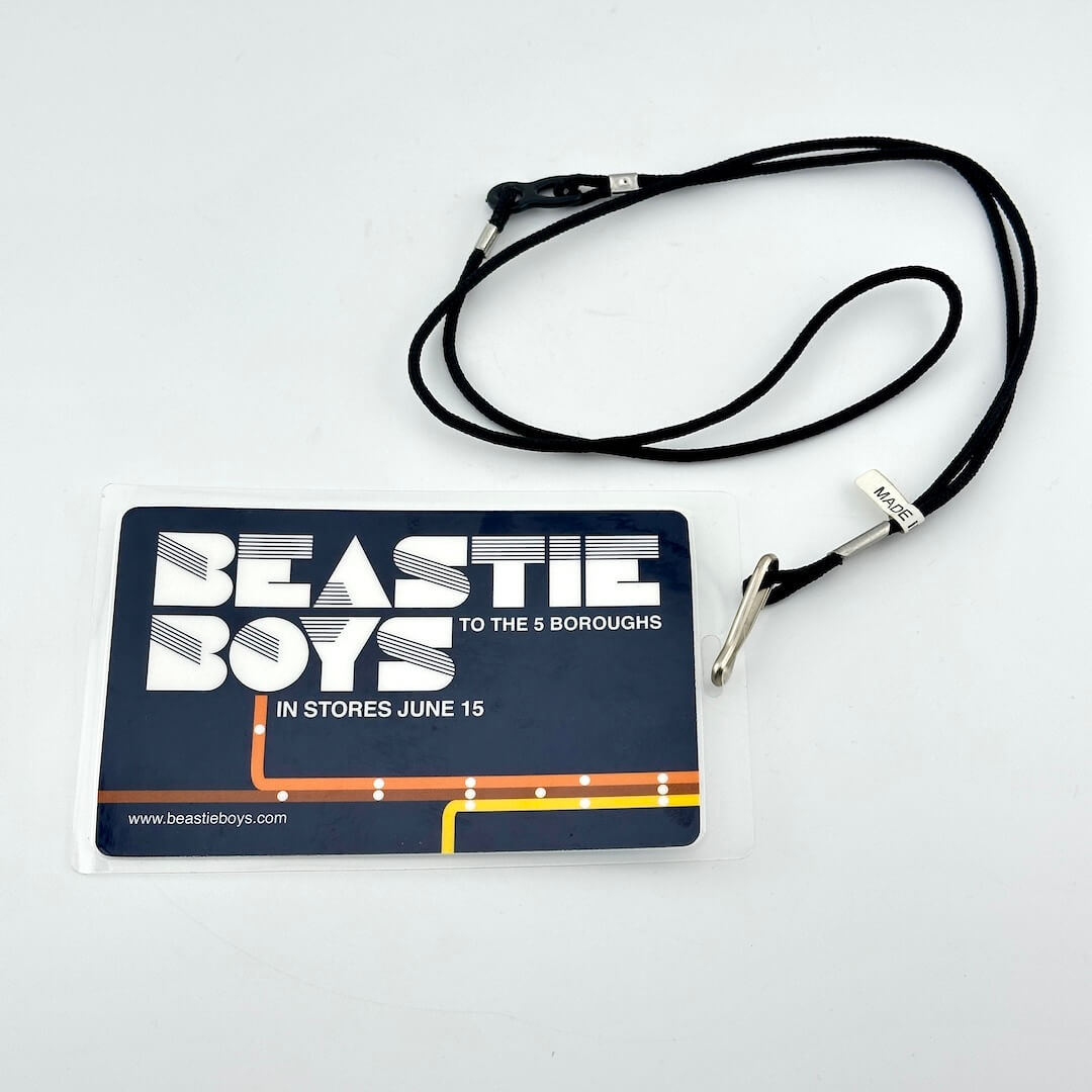 Beastie Boys promotional badge with lanyard on a white background