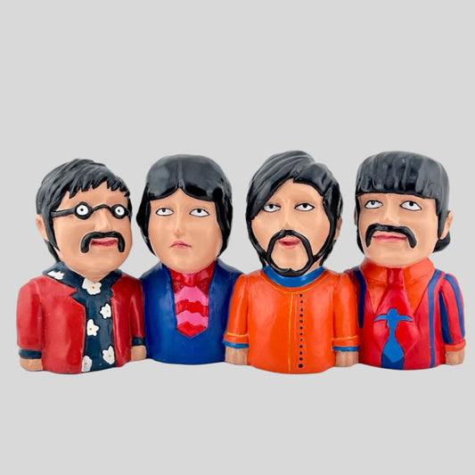 Ceramic artistic depictions of the four Beatles members in their yellow submarine style. Front view.