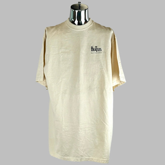 Front of tan short sleeved shirt with Beatles logo above left breast. No visible damage.