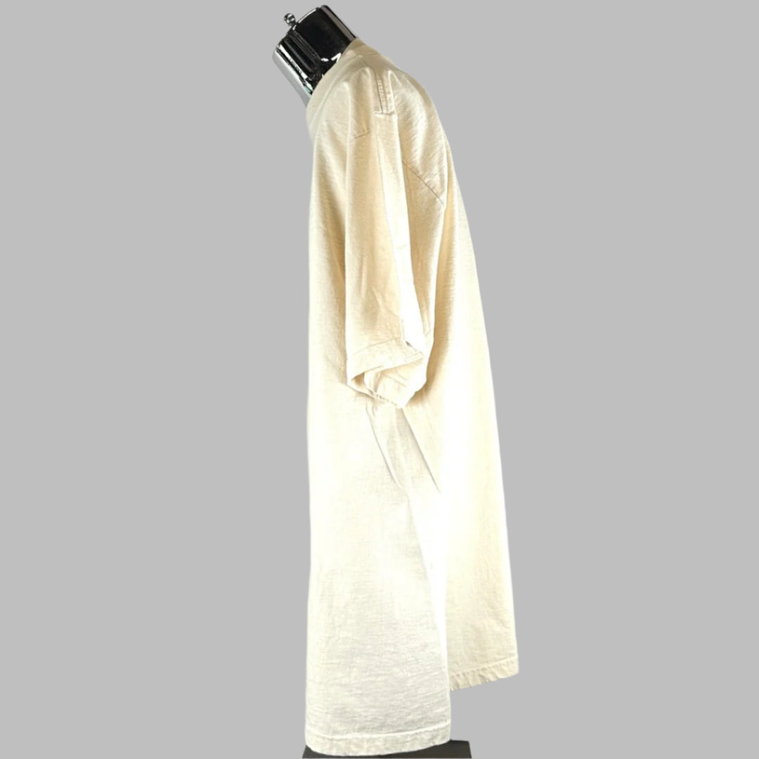 Left side of tan short sleeved shirt, no graphics or damage visible.