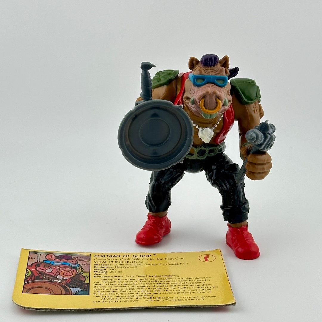 Anthropomorphic hog in pants, vest, with nosering & armor, holding gun, knife & sewer lid shield. With ID card.