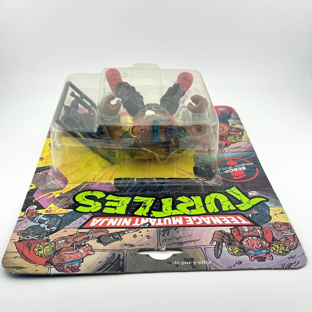 Toy figure in a transparent plastic dome on a colorful packaging background