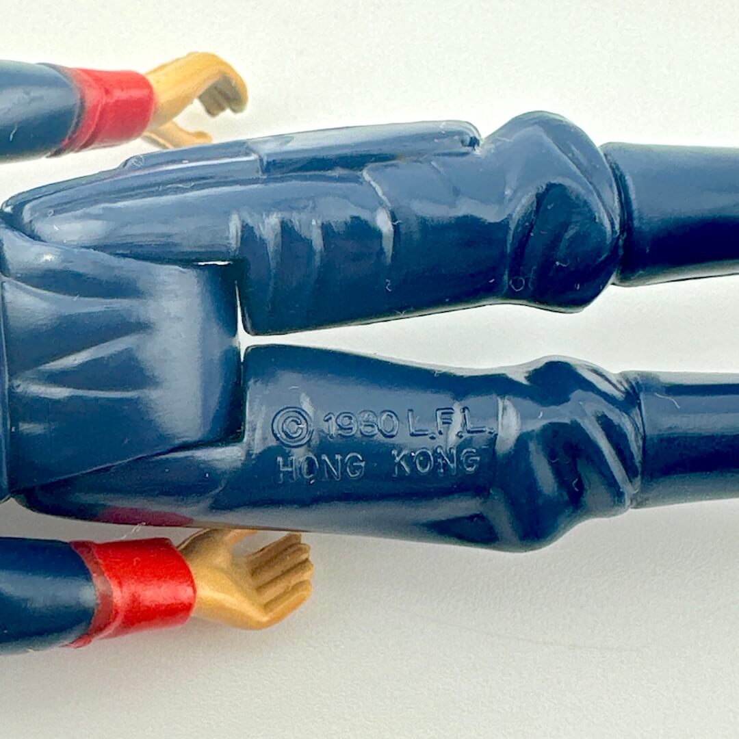 Close-up of back of figure's legs to show COO and copyright information.