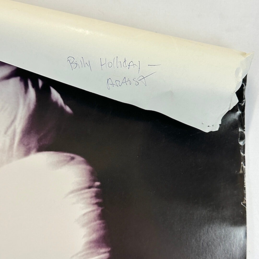 Top right corner rolled down to show pen note on reverse side.