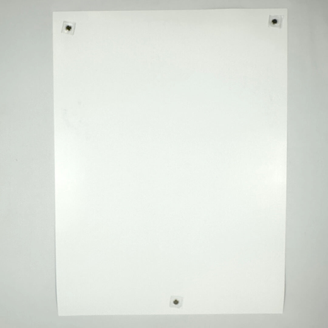 Backside of white poster showing no damage to face, corners, or edges, against white background.