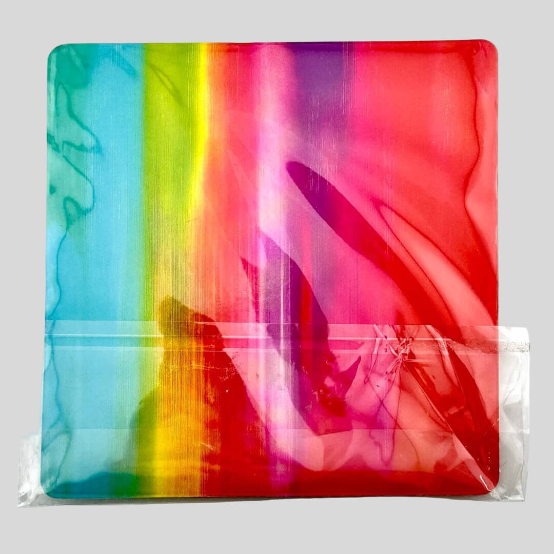 Backside of rainbow ombre card backing, wrapped in plastic.