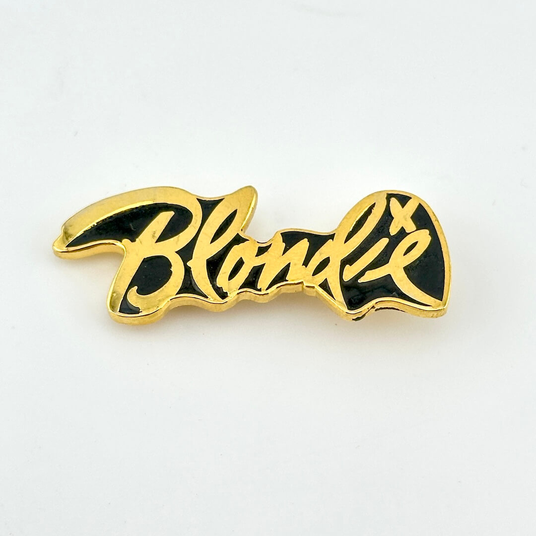 Gold text reading "Blondie" with black background to form pin.
