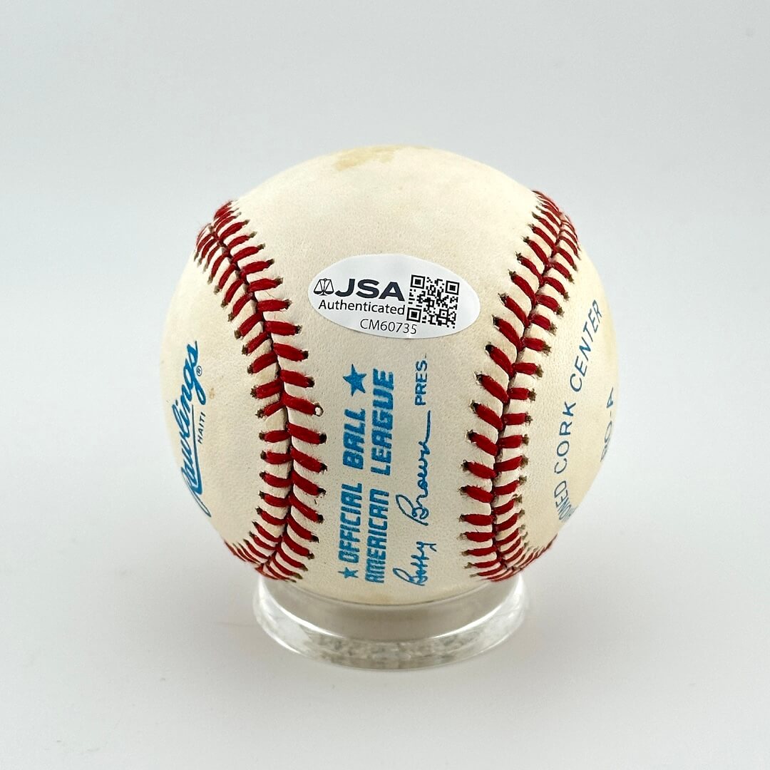 Baseball with red stitching on a white background